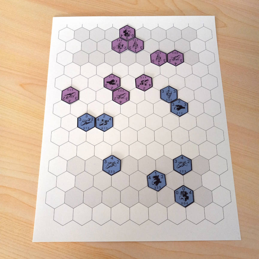 Picture of a game prototype showing a hex grid printed on letter sized paper with homemade game pieces in play.